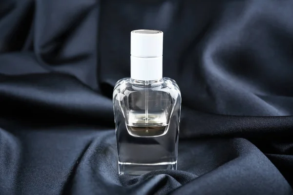 Perfume bottle on cloth — Stock Photo, Image