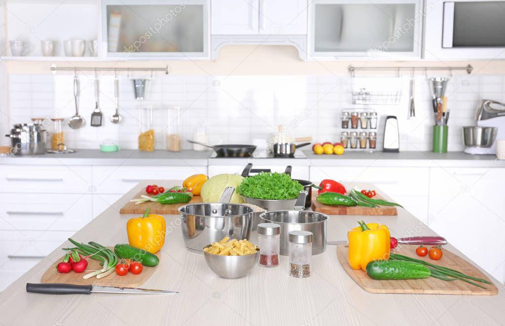 Fresh vegetables and utensils for cooking classes on wooden table