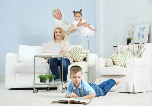 Grandson looking through photo album at home — Stock Photo, Image