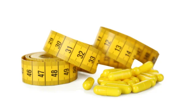 Viktminskning kosttillskott och måttband — Stockfoto