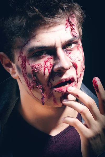 Young man with Halloween makeup on dark background, closeup — Stock Photo, Image