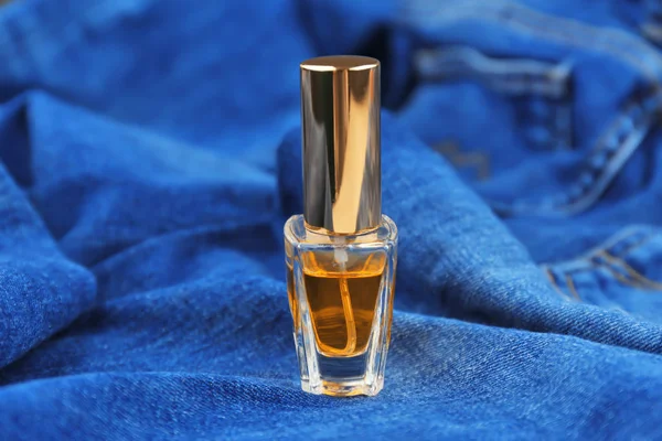 Perfume bottle on cloth — Stock Photo, Image