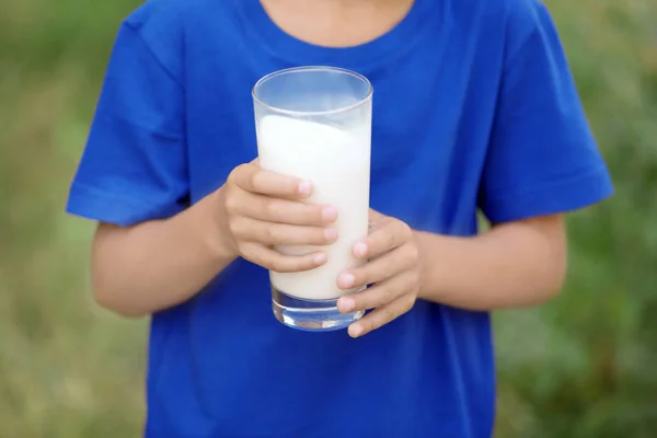 Mały chłopiec trzyma szklankę mleka — Zdjęcie stockowe