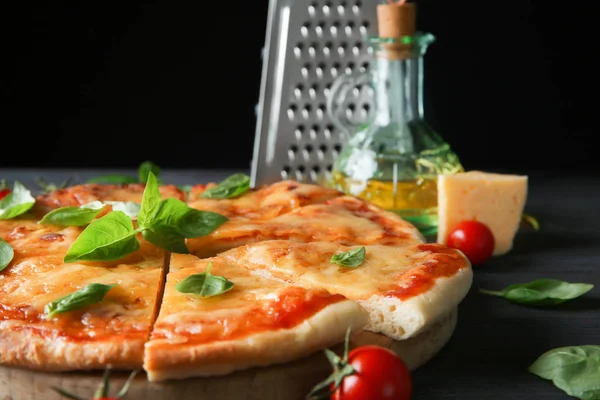 Tasty sliced pizza with basil leaves — Stock Photo, Image