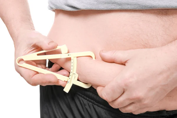 Fat man with measuring caliper — Stock Photo, Image