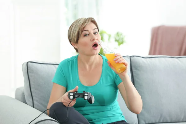 Mature woman playing videogame