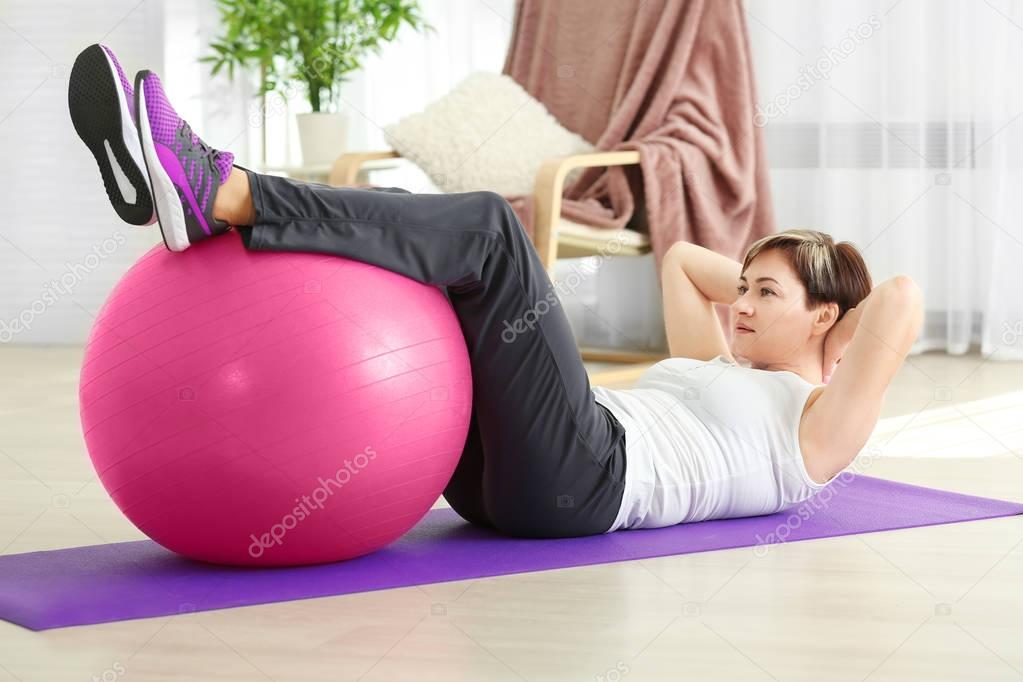 Mature woman training with fitball 