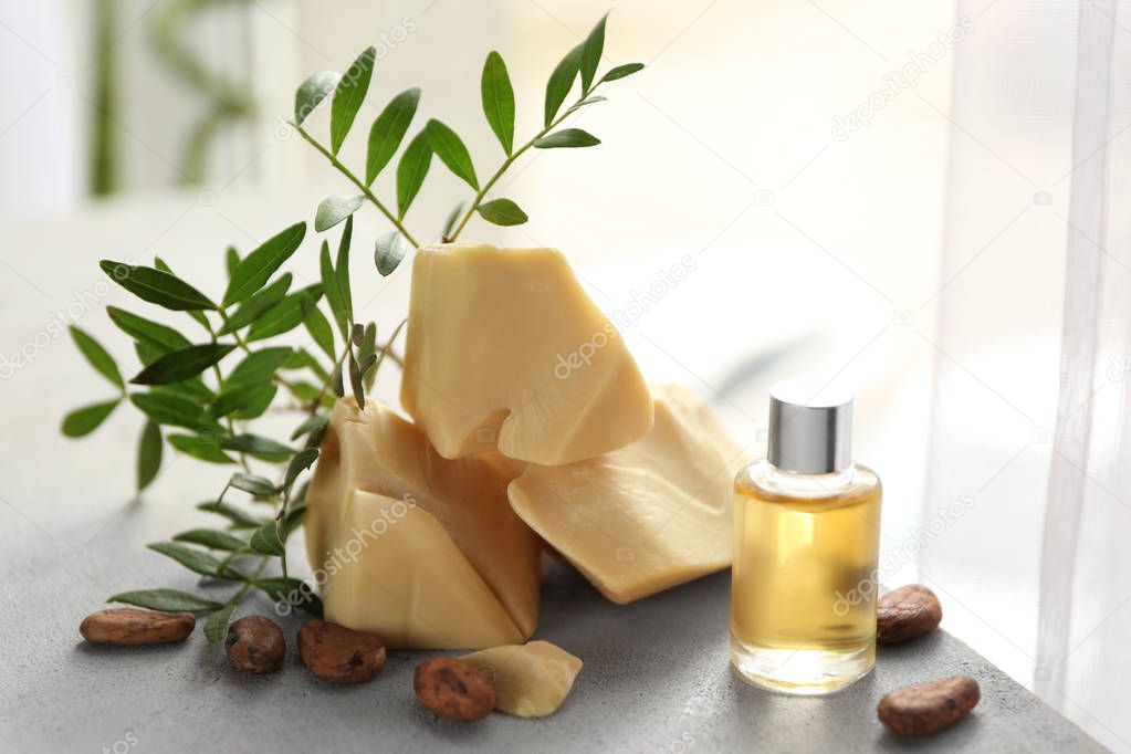 Beautiful composition with ingredients for cocoa butter lotion on table