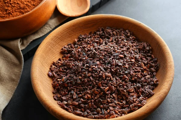 Cocoa nibs in wooden bowl — Stock Photo, Image