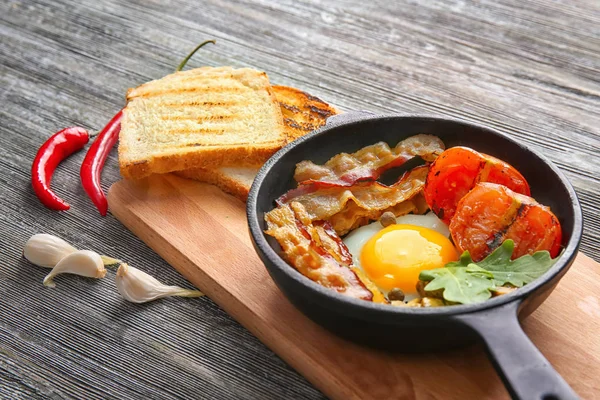 Kızartma tavası lezzetli yumurta, pastırma ve domates ile — Stok fotoğraf