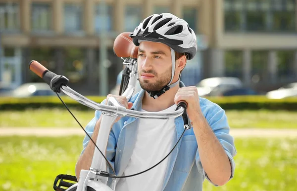 Young man carrying bicycle — Stock Photo, Image