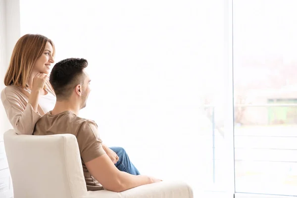 Couple sitting in armchair Stock Photo