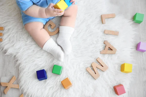 Cute baby with word LIAM — Stock Photo, Image