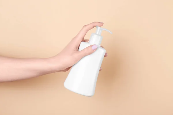 Hand with bottle of cosmetic product — Stock Photo, Image