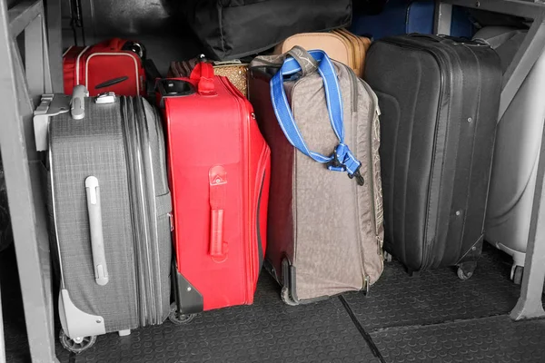 Different suitcases in luggage bay — Stock Photo, Image