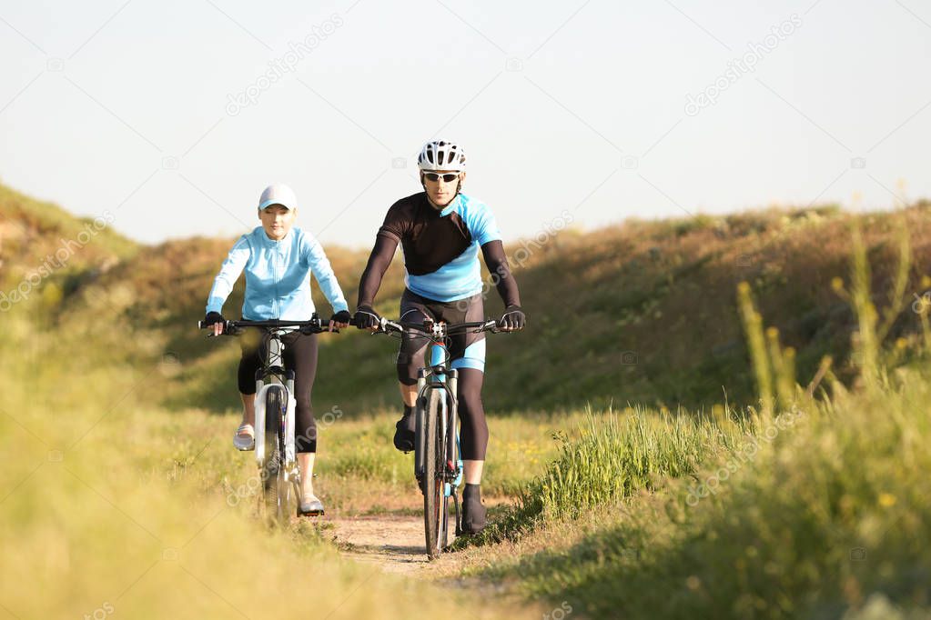 Sporty cyclists riding bicycles 