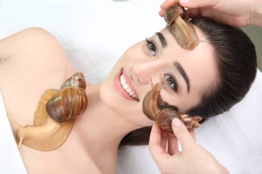 woman undergoing treatment with Achatina snails clipart