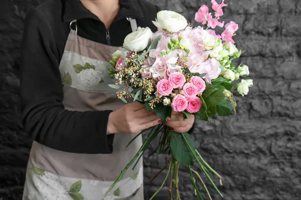Female florist creating beautiful bouquet