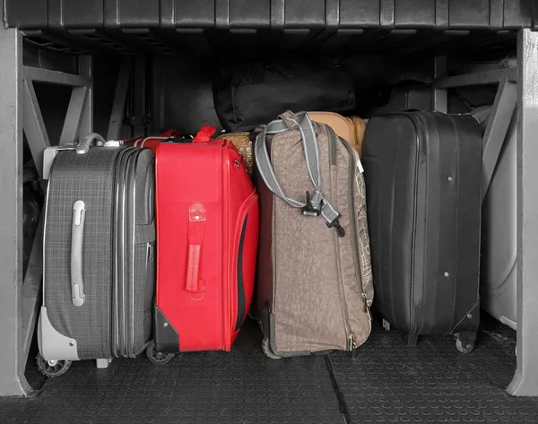 Different suitcases in luggage bay — Stock Photo, Image