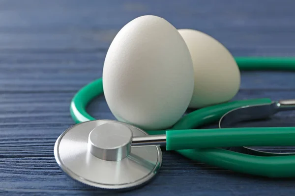 Eggs with medical stethoscope — Stock Photo, Image