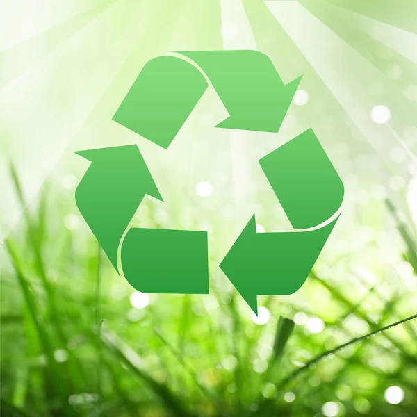 Symbol of recycling and green grass — Stock Photo, Image