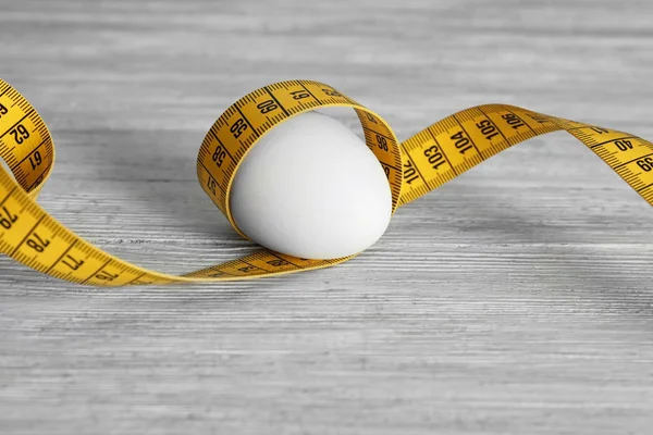 Egg with measuring tape Stock Picture