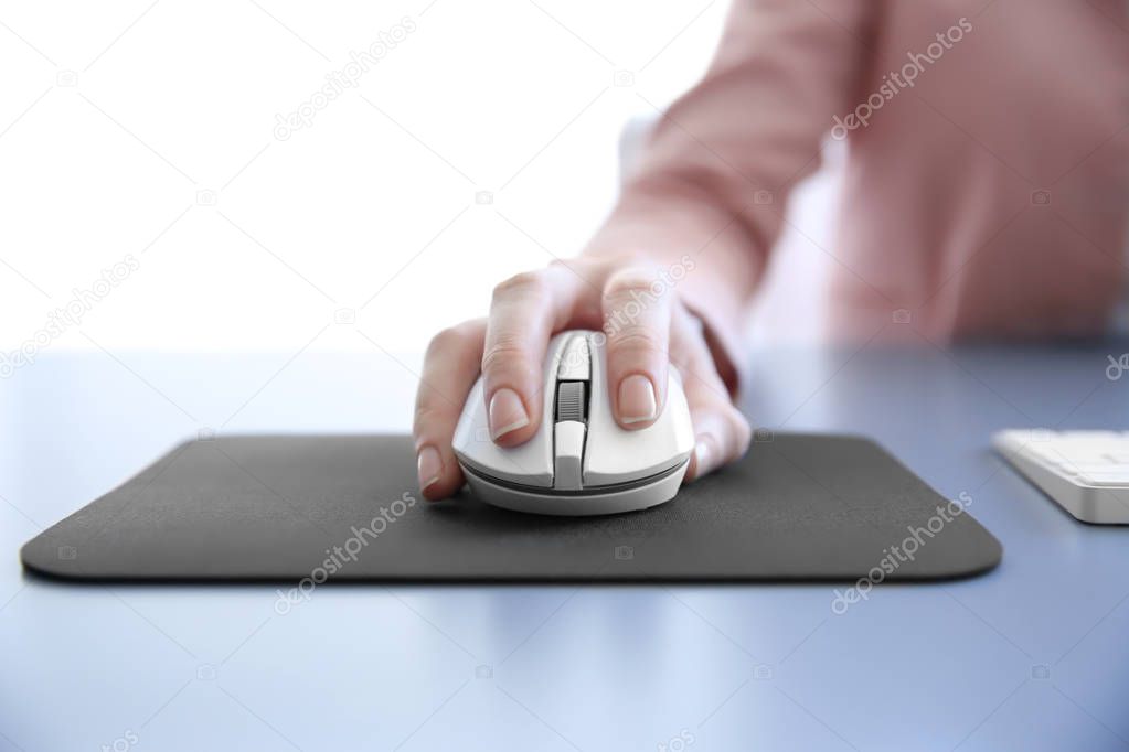 Female hand holding computer mouse 