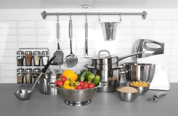 Utensils and vegetables for cooking classes on table in kitchen — Stock Photo, Image