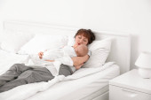 Mladá žena s roztomilé spící dítě ležící na posteli doma