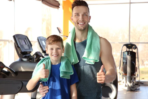 Dad and son in gym