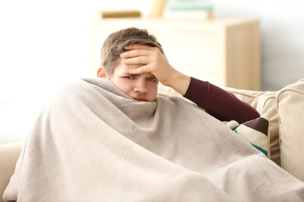 Young ill man covered with plaid — Stock Photo, Image