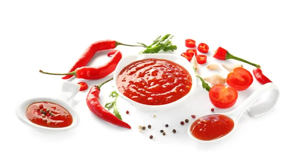 Tasty chili sauce in bowl and ingredients on white background — Stock Photo, Image