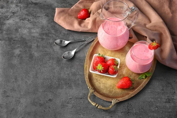 Fresh yogurt smoothie with strawberry on grunge background — Stock Photo, Image