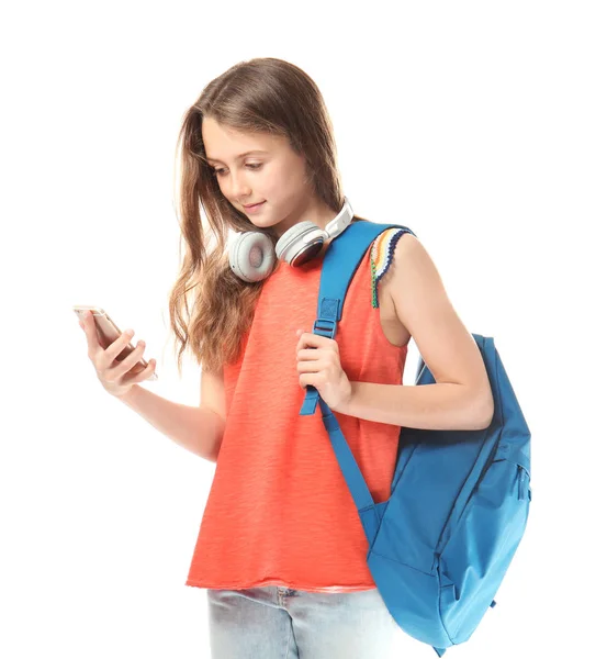 Cute teenager girl with mobile phone, headphones and schoolbag on white background — Stock Photo, Image