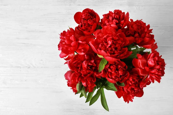 Top view of beautiful peonies on wooden table — Stock Photo, Image