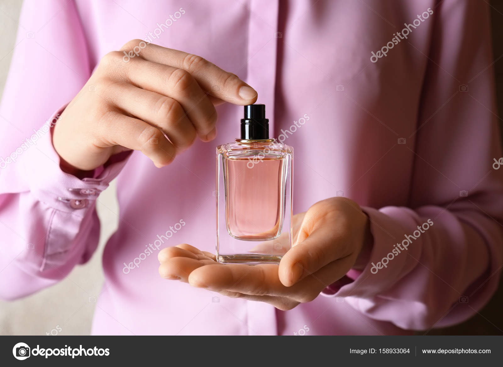 Hands holding perfume bottle — Stock Photo © belchonock #158933064