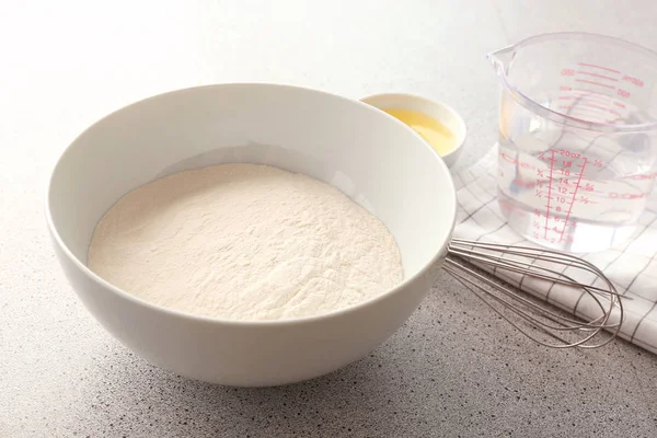 Bowl with flour and ingredients — Stock Photo, Image