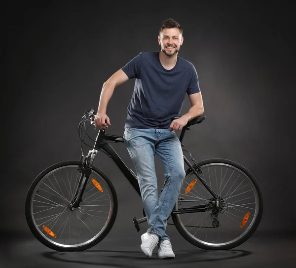 Handsome young man riding bicycle on white background Stock Photo