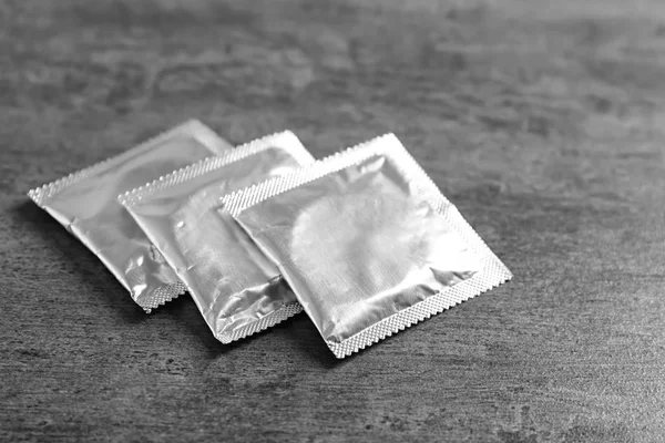 Three condoms in packaging — Stock Photo, Image