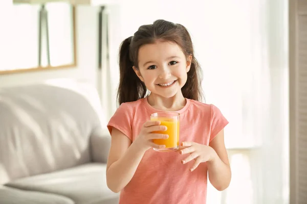 Cute little girl with glass of juice — Stock Photo, Image