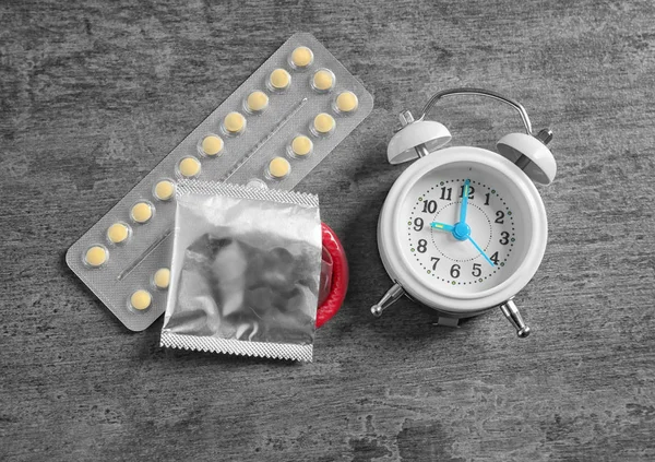 Contraceptives and alarm clock — Stock Photo, Image