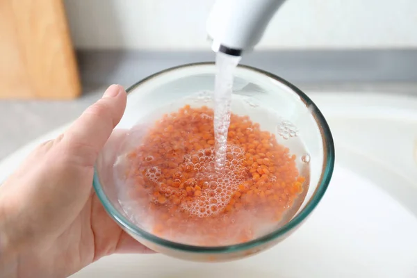 Hand of woman washing raw lentils — Stock Photo, Image