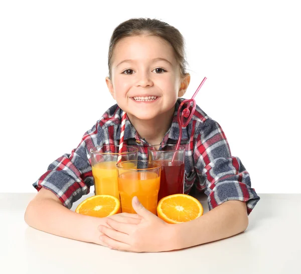 Cute little girl with glasses of juice — Stock Photo, Image