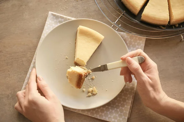 Женщина ест вкусный сырный торт — стоковое фото