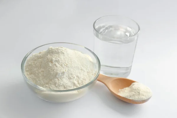 Flour and water on white background — Stock Photo, Image