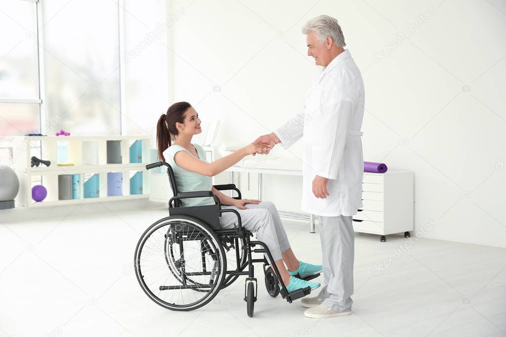 disabled woman with senior orthopedist