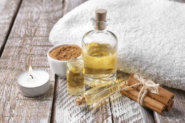 Ahşap zemin üzerine tarçın yağı şişe ile kompozisyon