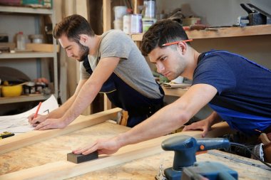 young carpenters working in shop clipart