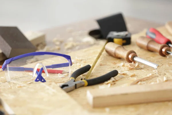 Table with tools in carpenter's workshop, closeup — Stock Photo, Image