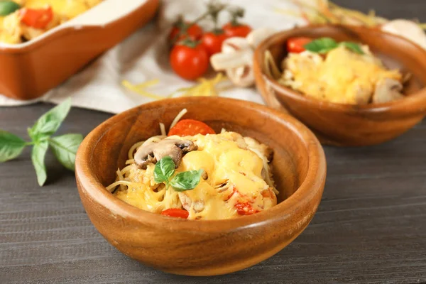 Tigelas de madeira com delicioso tetrazzini de peru assado na mesa da cozinha — Fotografia de Stock